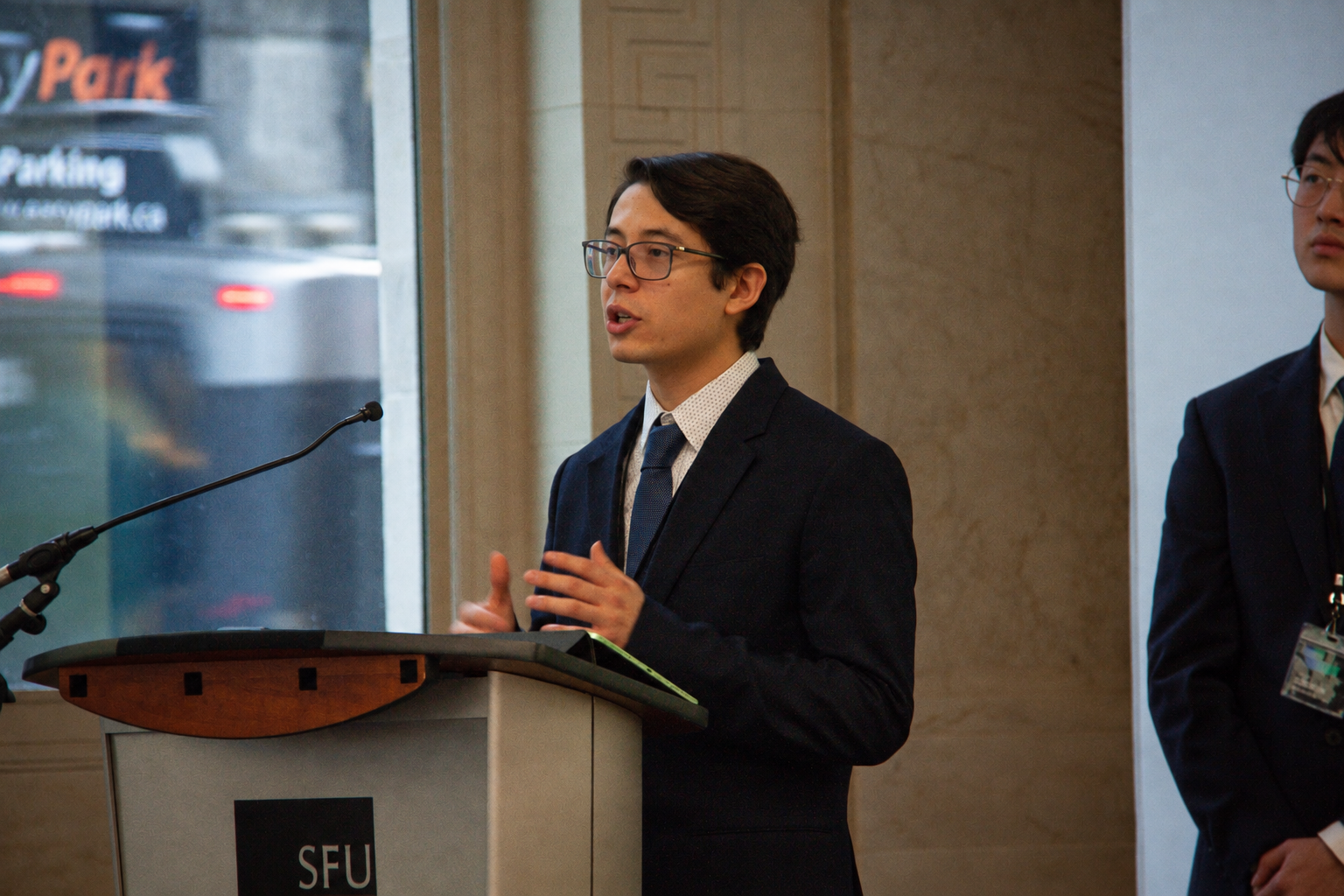 Nicolas presenting at the podium during the Axis Consulting final presentation